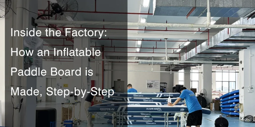 Factory workers in a production facility assembling inflatable paddle boards, with several blue boards partially completed on tables.