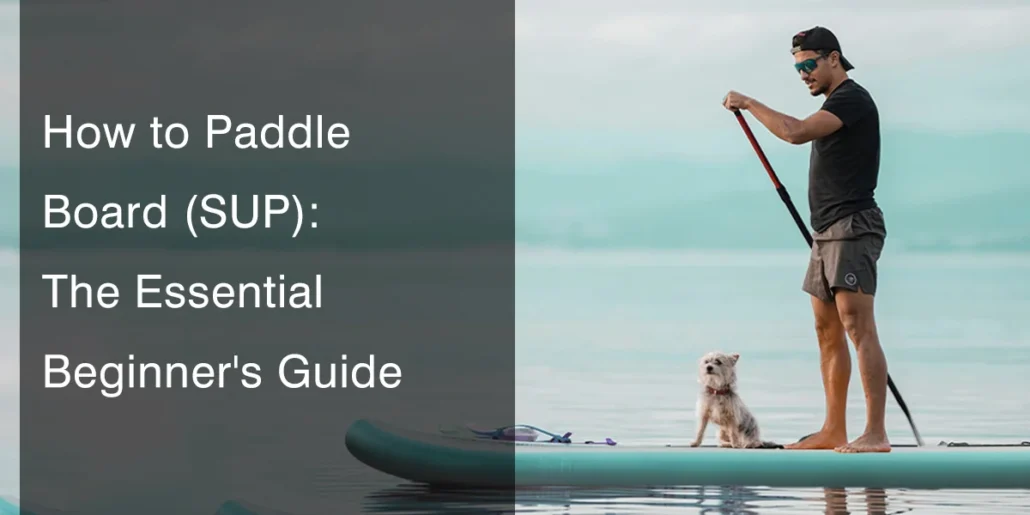 Man standing on a paddleboard holding an oar with a small dog sitting on the board in calm water.