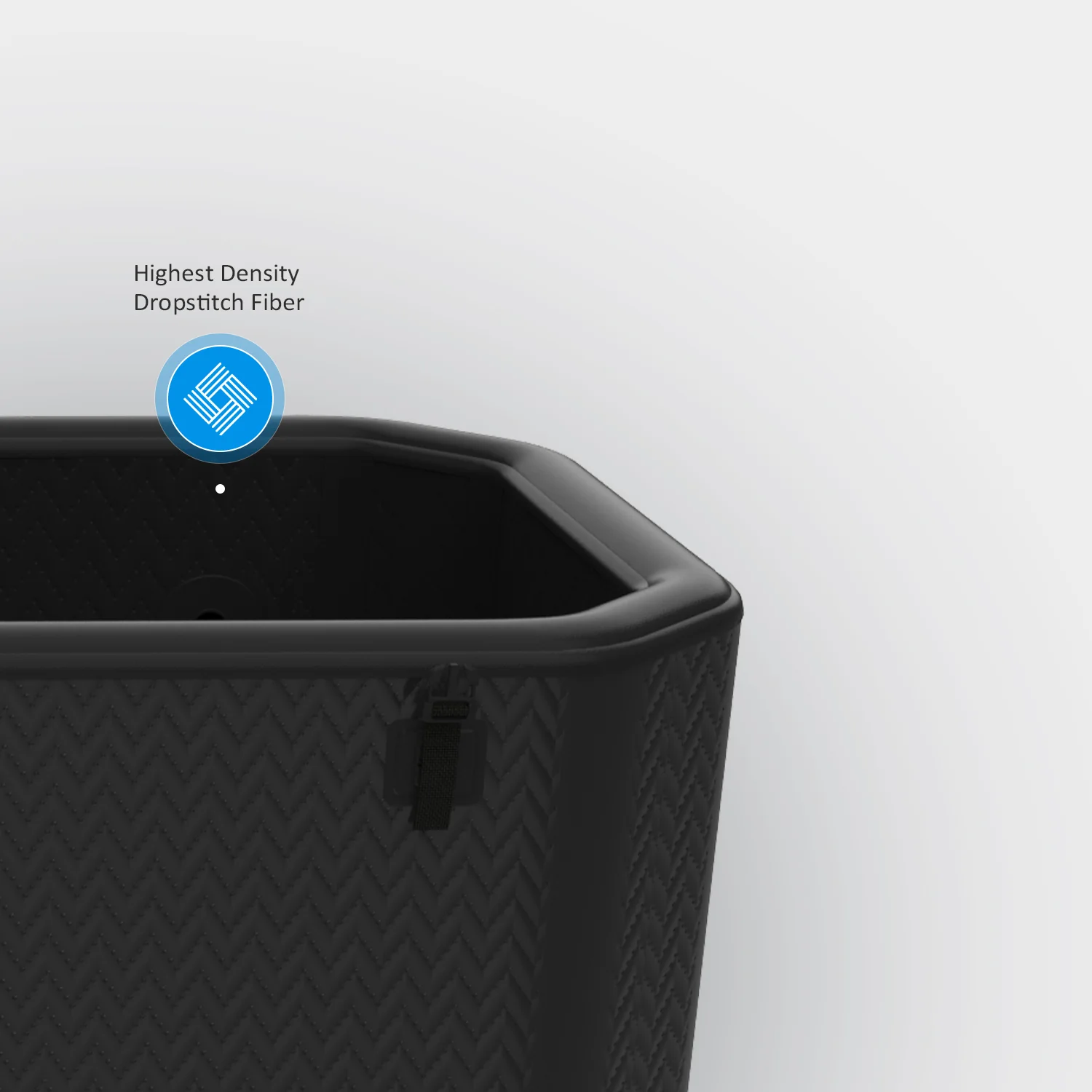 Close-up of black panel made from high-density dropstitch fiber, featuring a zigzag pattern and a strap with the word 'Highest Density Dropstitch Fiber' labeled.