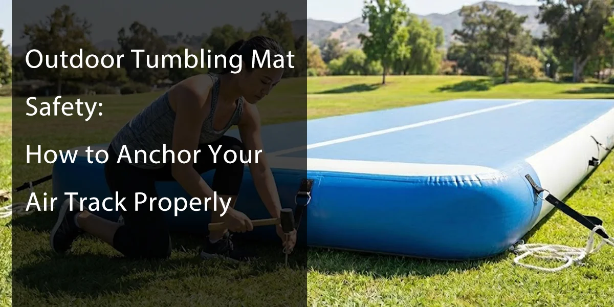Person securing an outdoor air track mat with anchors in a sunny park setting.