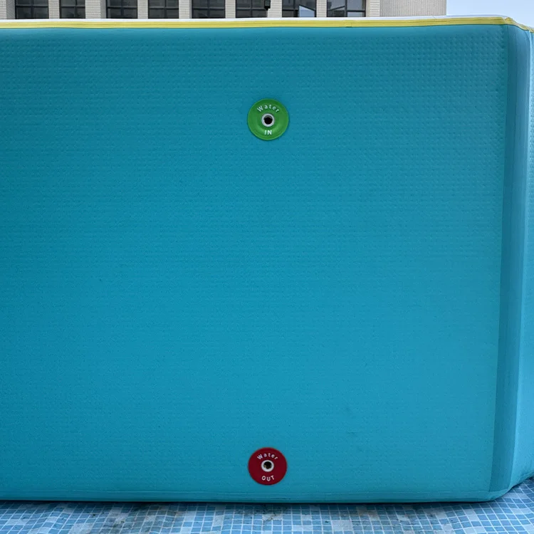 Blue water tank showing green inlet valve labeled 'Water IN' and red outlet valve labeled 'Water OUT'.