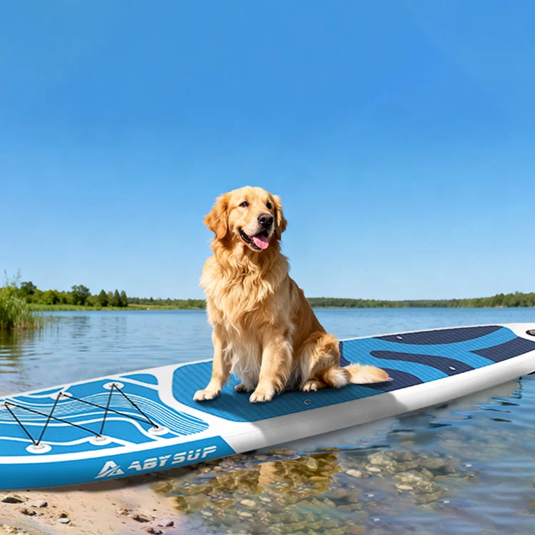 Golden retriever sitting on a blue paddleboard by the lake on a clear day.