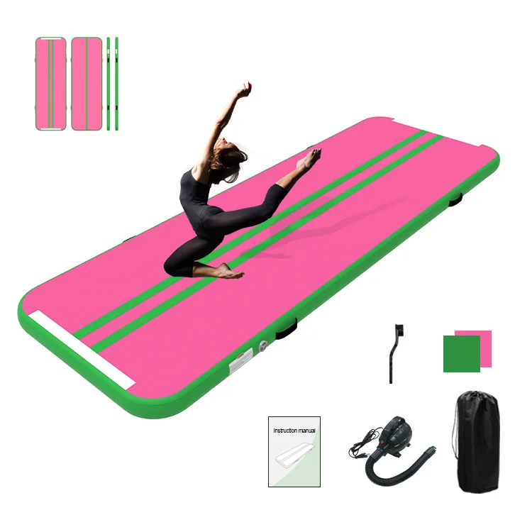 Gymnast performing a leap on a pink and green inflatable air track with included accessories like a pump and carrying bag.