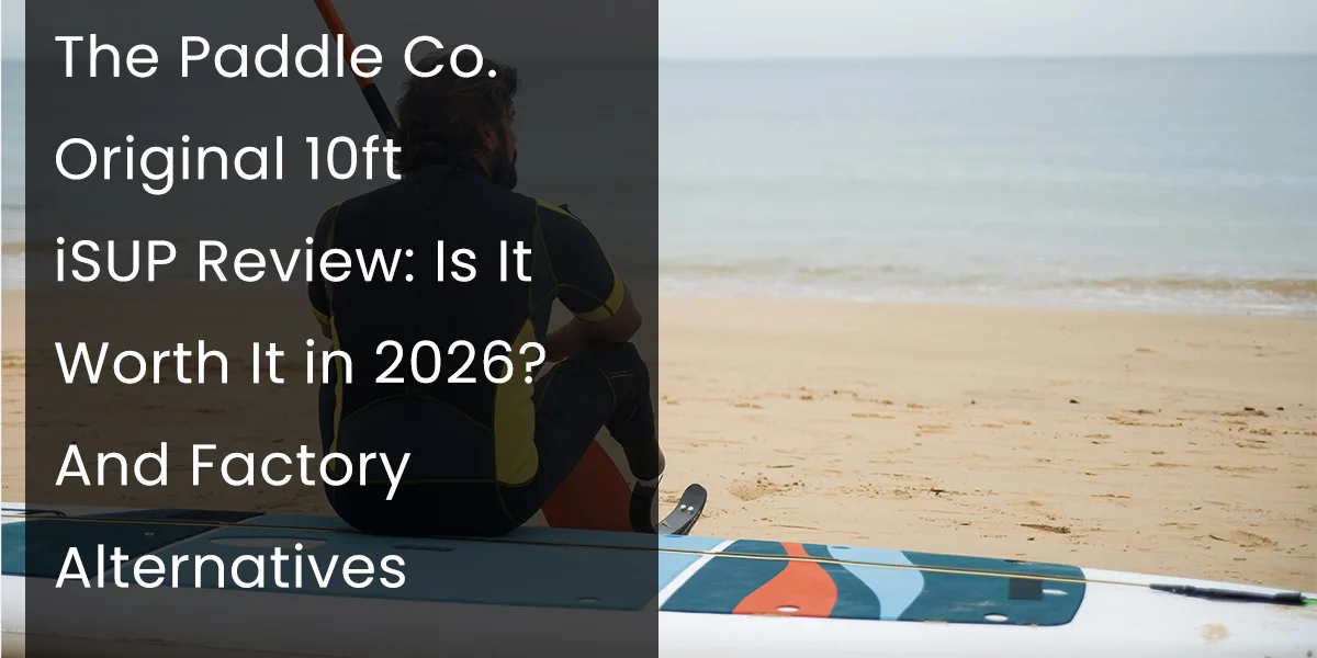 Person sitting on a paddleboard at the beach beside the ocean, with overlay text reviewing The Paddle Co. 10ft iSUP.
