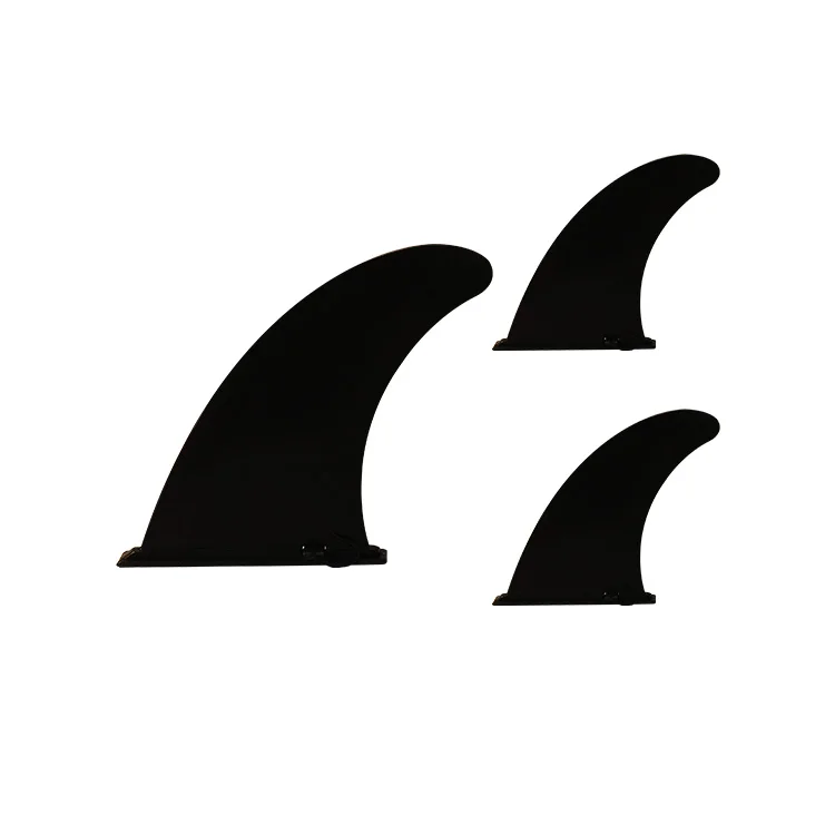 Three black surfboard fins of varying sizes on a white background, suitable for enhancing stability and control in surfing.