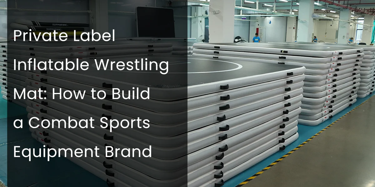 Factory interior with stacked inflatable wrestling mats on the floor, showcasing production environment for combat sports equipment.
