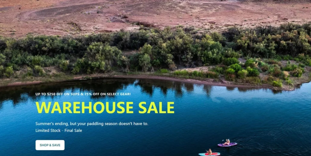 Scenic view of a calm lake with paddleboarders in the foreground and warehouse sale text offering discounts on SUP gear.