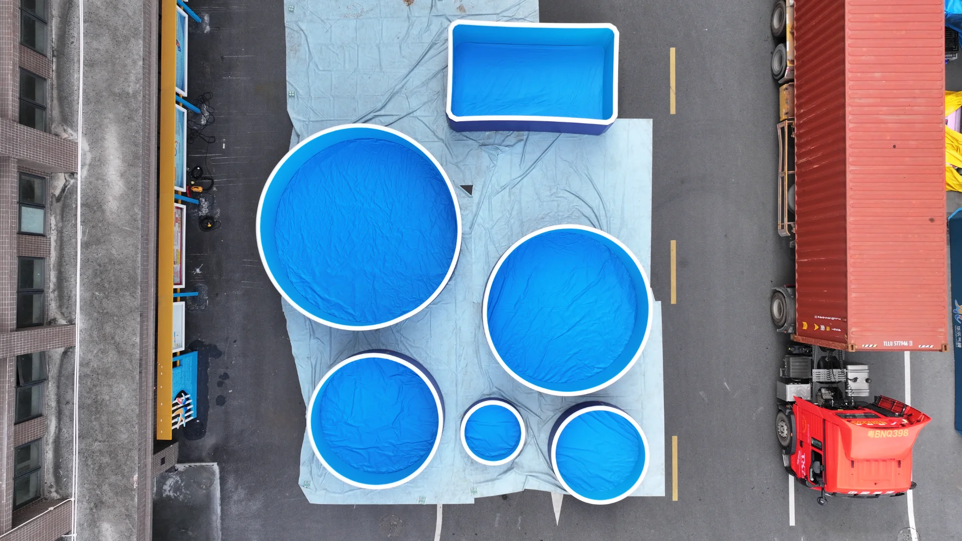 Blue portable pools prepared near a truck for shipping