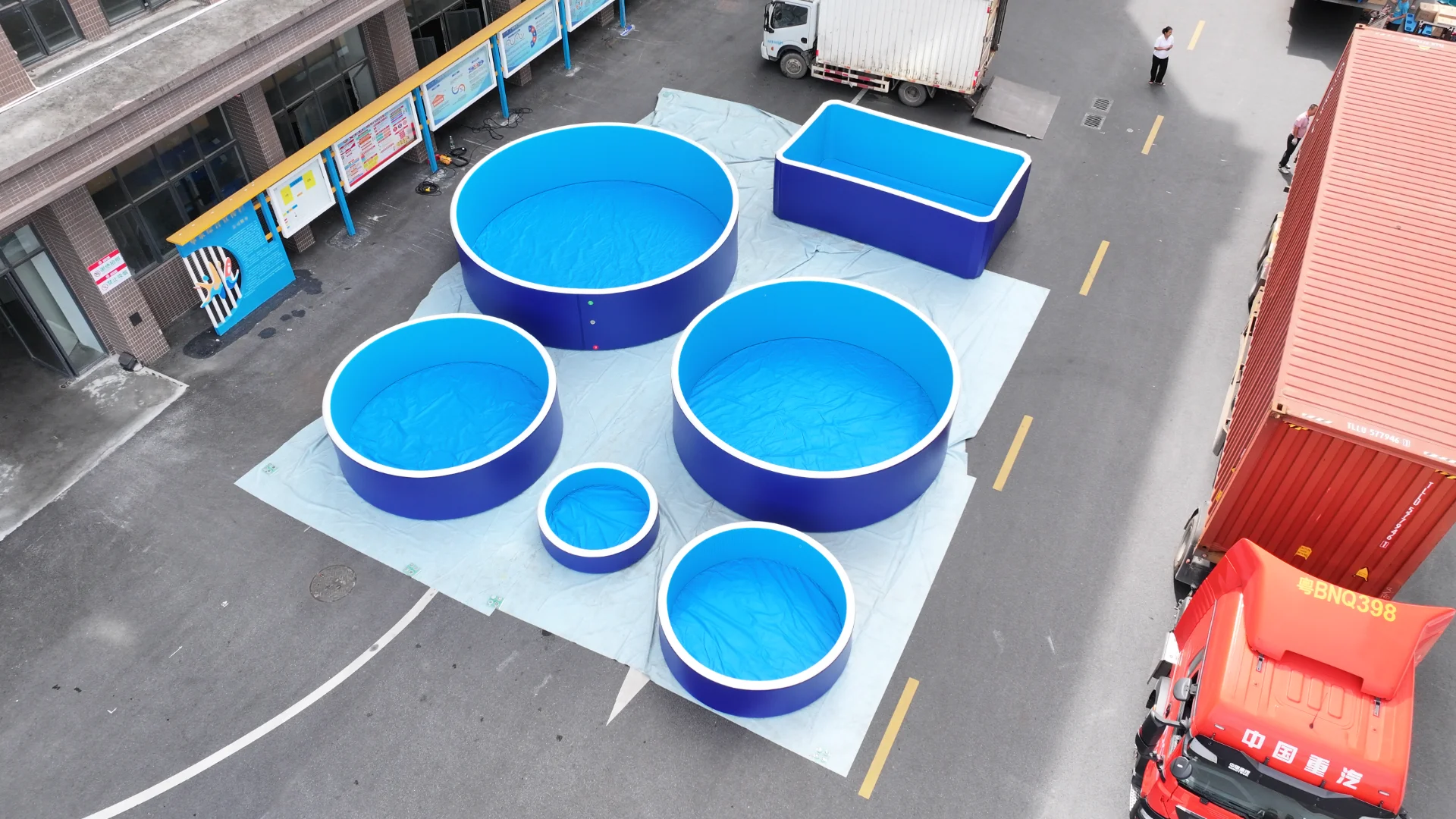 Round and rectangular blue drop stitch pools outdoors