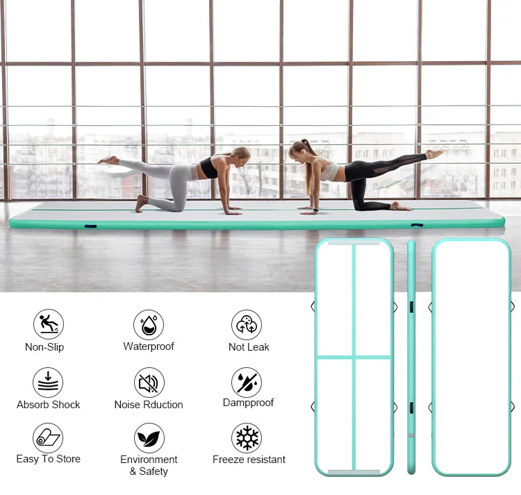 Two women in athletic wear exercising on a large inflatable air mat in a bright gym space with large windows. Icons below highlight features like non-slip, waterproof, and shock absorption.
