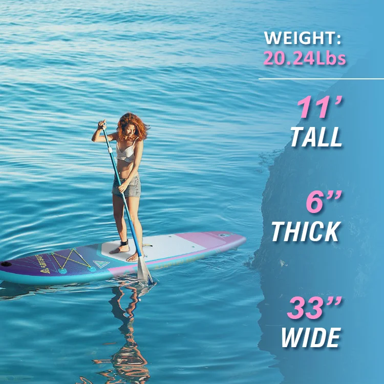 A woman paddling on a pink and blue stand-up paddleboard in calm blue waters with specifications about the board displayed on the side.