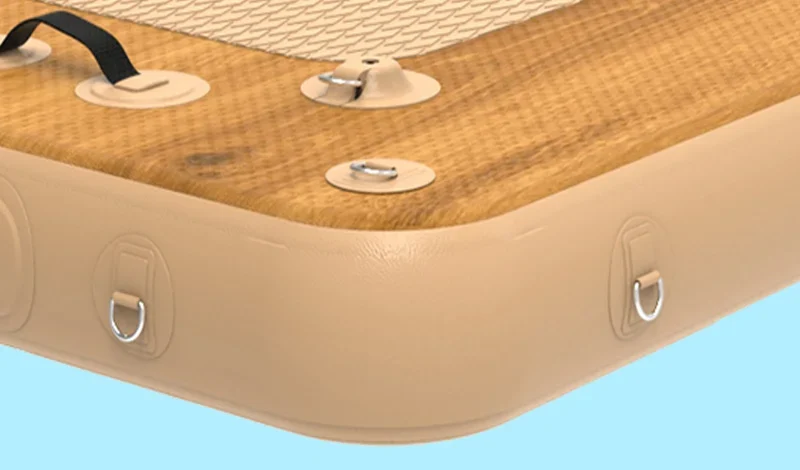 Corner section of an inflatable platform with a wooden-textured surface, handles, metal D-rings, and a 30cm (12 inches) thickness label.