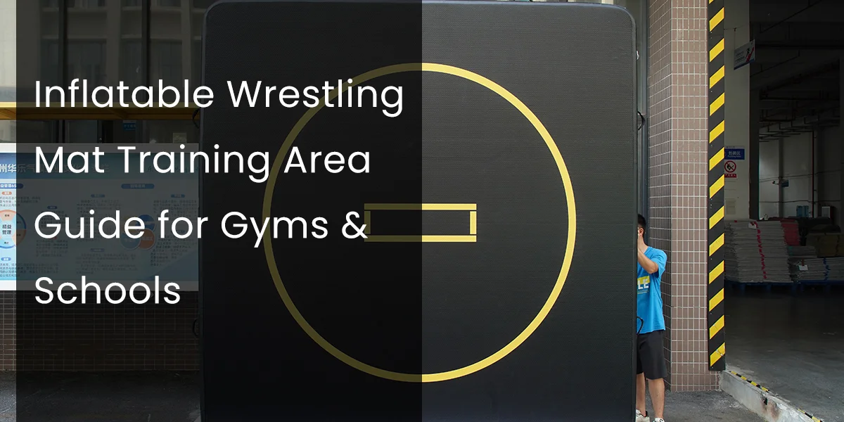 Large black inflatable wrestling mat with a yellow circle design being set up outdoors near a building by a person.