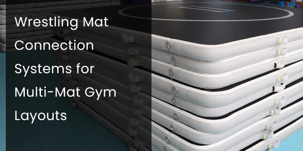 Stack of white and black wrestling mats with connection systems for multi-mat gym layouts.